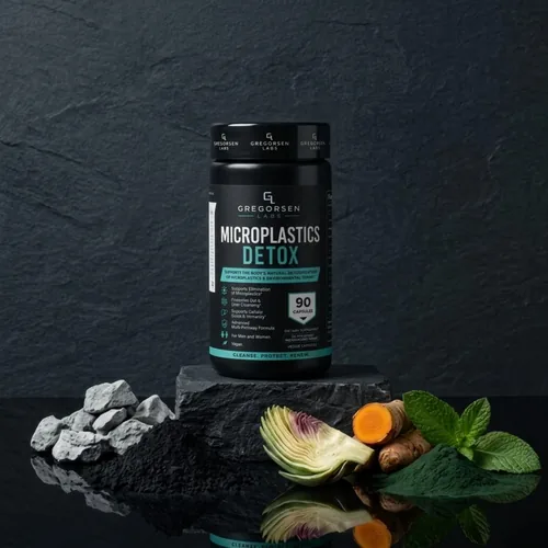 Gregorsen Labs Microplastics Detox bottle on a stone podium surrounded by the raw ingredients